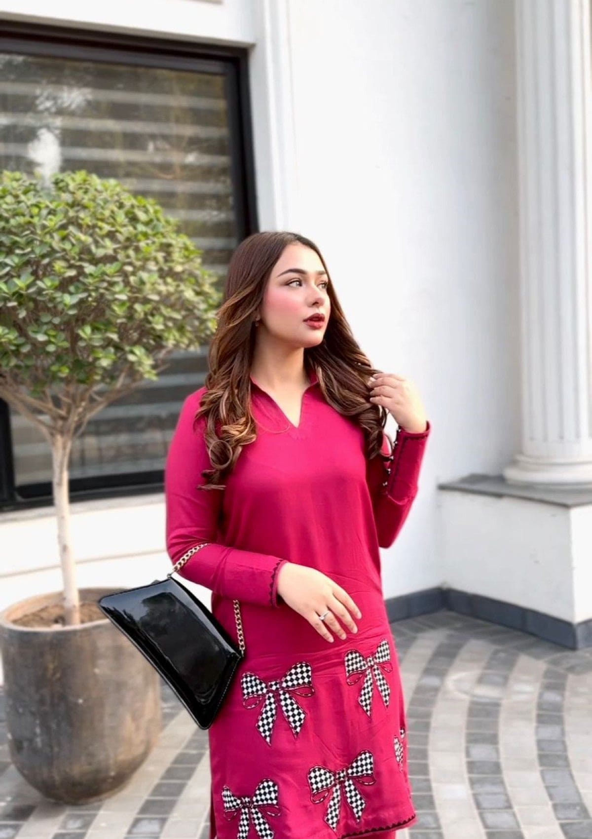 Bowlicious is a hot pink marina shirt with black and white bow check embroidery
